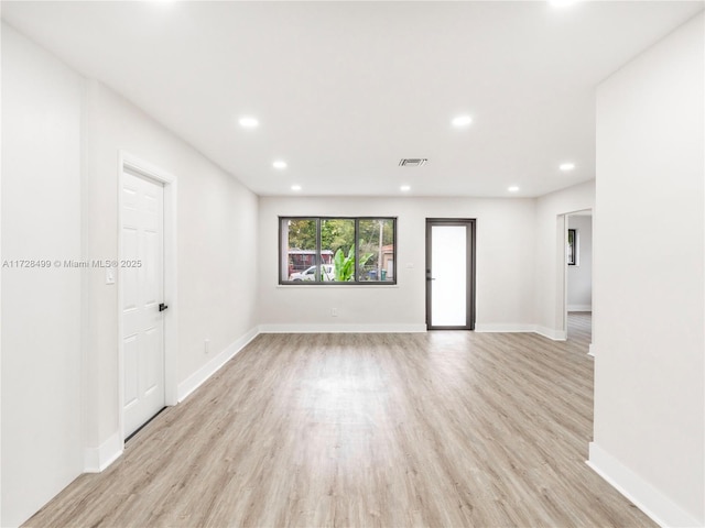 spare room with light hardwood / wood-style floors