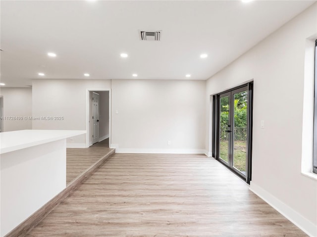 spare room with light hardwood / wood-style floors