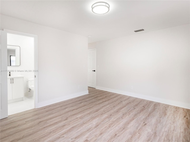 spare room with light hardwood / wood-style flooring