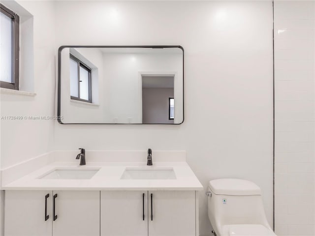 bathroom featuring vanity and toilet