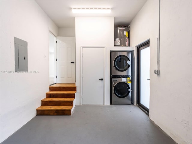 interior space with stacked washer / drying machine, electric panel, and electric water heater