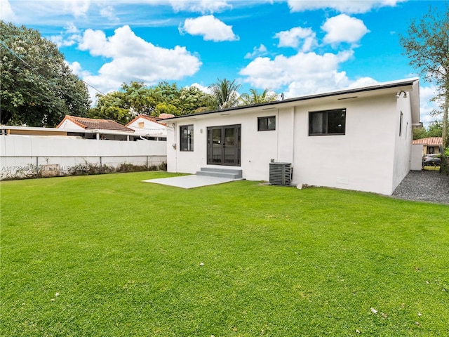 rear view of house featuring a yard, a patio area, and central air condition unit