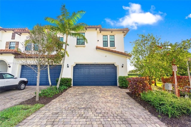 mediterranean / spanish home with a garage