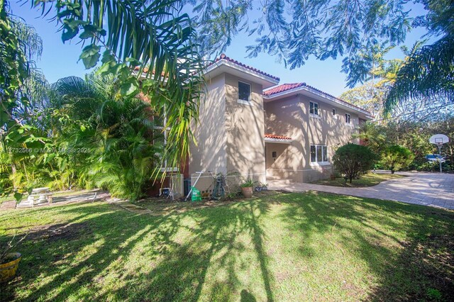 view of side of home featuring a lawn