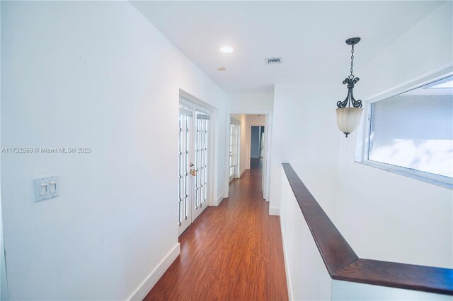 corridor featuring dark hardwood / wood-style flooring and plenty of natural light