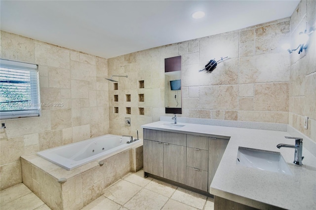 bathroom with tile walls, vanity, and tiled shower / bath