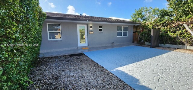 back of property with a patio