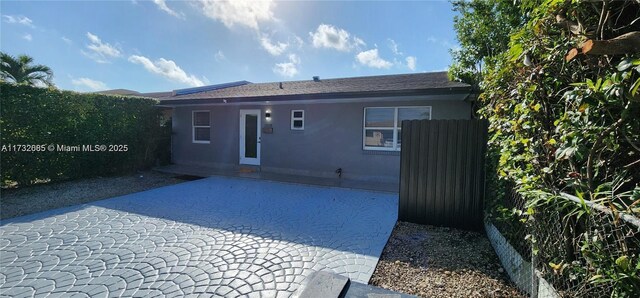 rear view of property featuring a patio