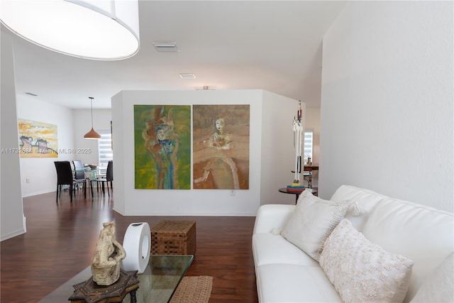 living room featuring dark hardwood / wood-style floors and a wealth of natural light