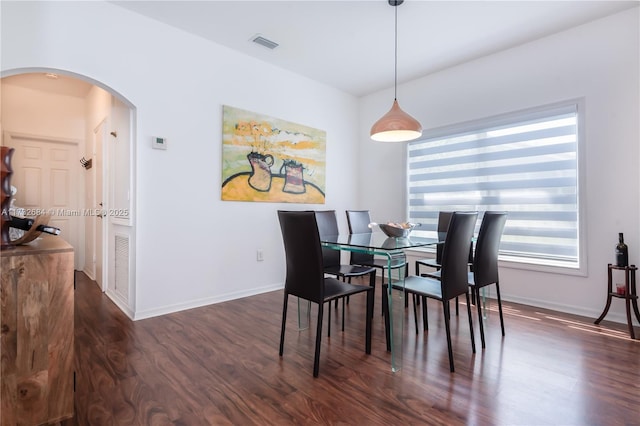 dining space with dark hardwood / wood-style floors