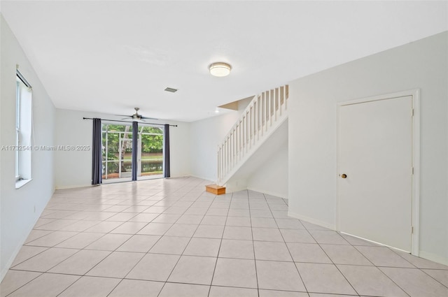 unfurnished room with light tile patterned floors and ceiling fan