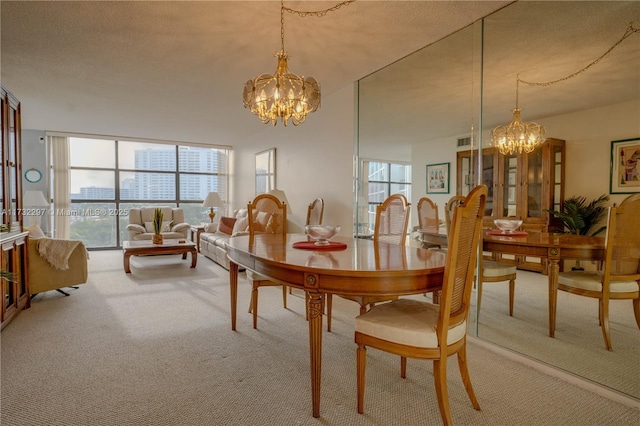 dining area featuring a wall of windows, carpet floors, a textured ceiling, and a notable chandelier