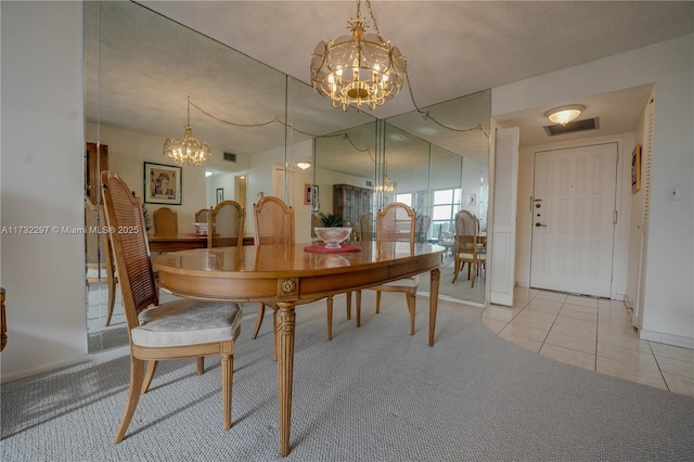 dining room featuring an inviting chandelier and light tile patterned floors