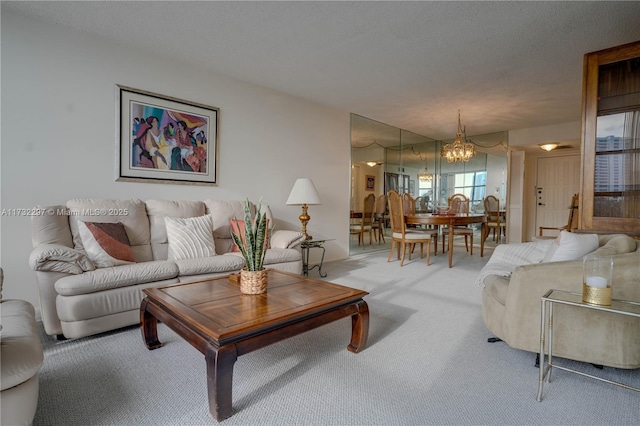 living room with carpet, a chandelier, and a textured ceiling