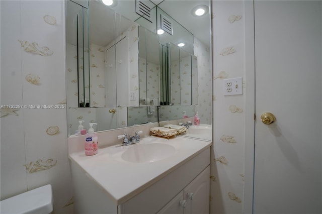 bathroom featuring vanity and toilet