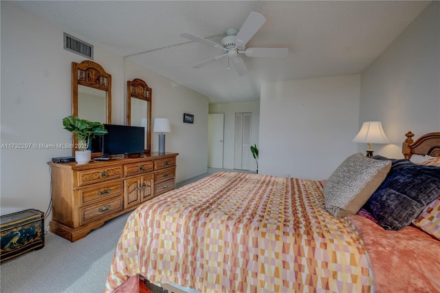 carpeted bedroom featuring ceiling fan and a textured ceiling