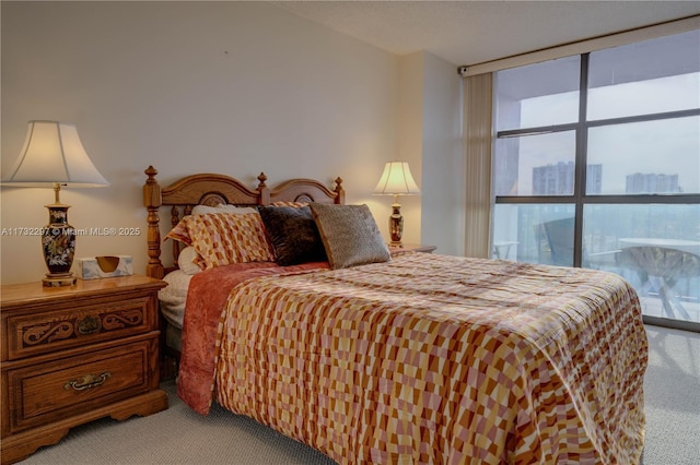 carpeted bedroom featuring floor to ceiling windows