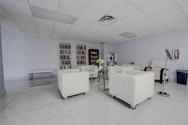 living room with a drop ceiling