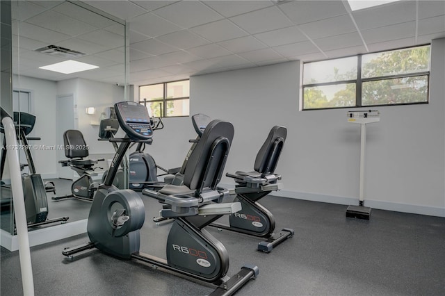 workout area featuring a drop ceiling