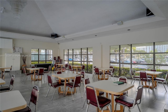 dining space featuring a high ceiling and a tray ceiling