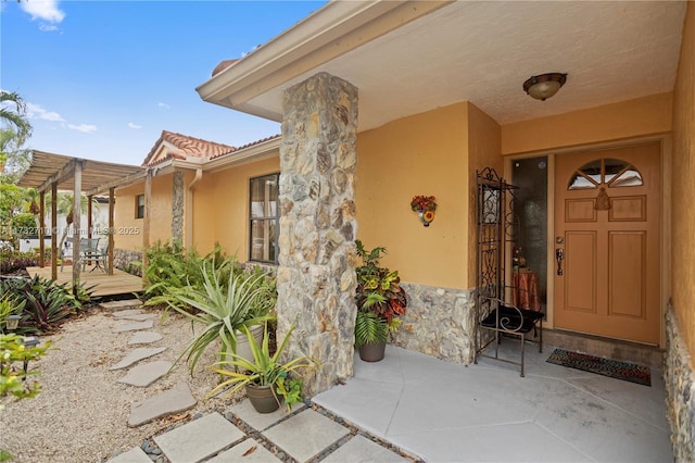 property entrance with a pergola