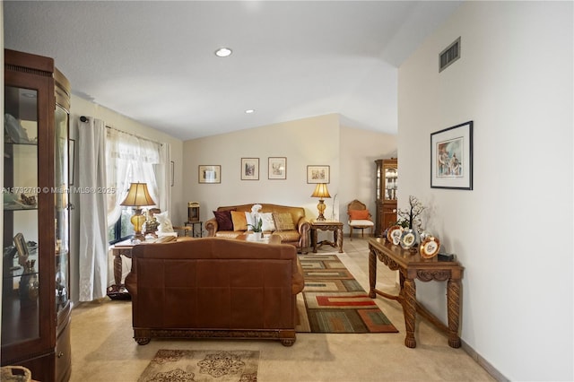 living room featuring light carpet and vaulted ceiling