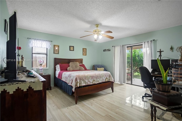 bedroom featuring a textured ceiling, access to outside, ceiling fan, and light wood-type flooring