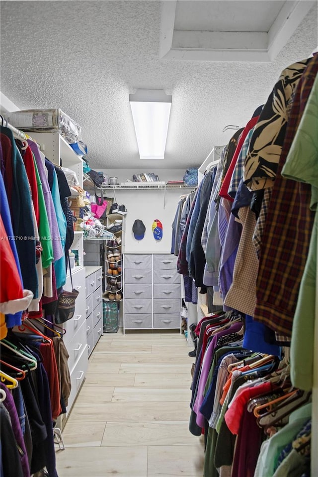 walk in closet with light wood-type flooring