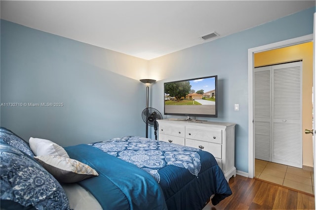 bedroom with dark hardwood / wood-style floors