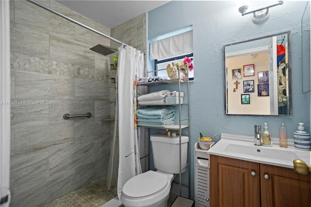 bathroom featuring a shower with curtain, vanity, and toilet