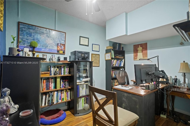 office area featuring ceiling fan, hardwood / wood-style floors, and a textured ceiling