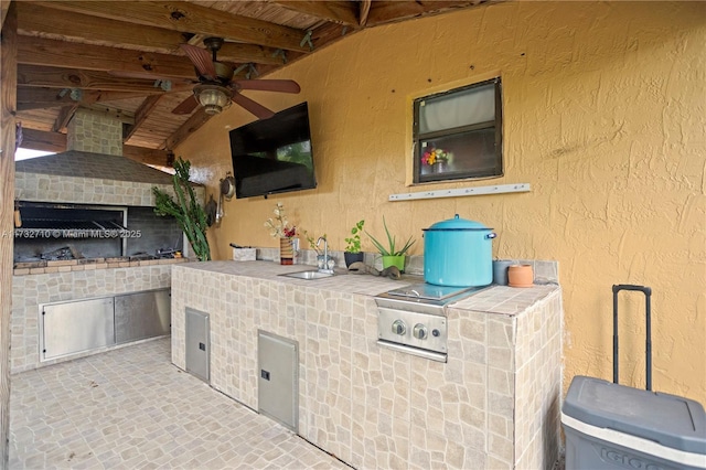 view of patio featuring area for grilling, sink, and ceiling fan