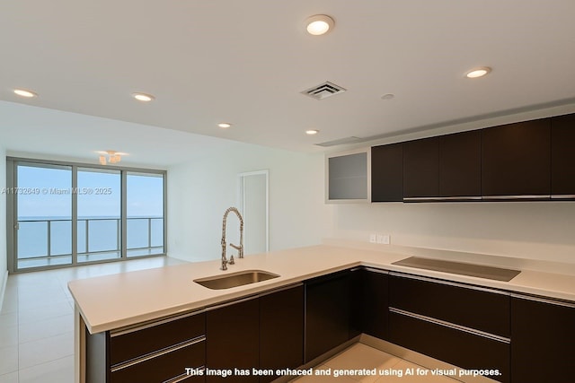 17001 Collins Ave Unit 1802, Sunny Isles Beach, FL 33160 - kitchen with a sink, a peninsula, cooktop, light countertops, and modern cabinets