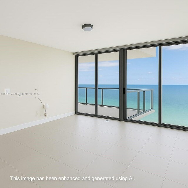 17001 Collins Ave Unit 1802, Sunny Isles Beach, FL 33160 - tiled spare room with a water view, baseboards, and floor to ceiling windows