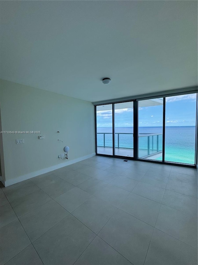 empty room with expansive windows and a water view