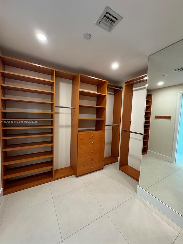 spacious closet featuring light tile patterned flooring