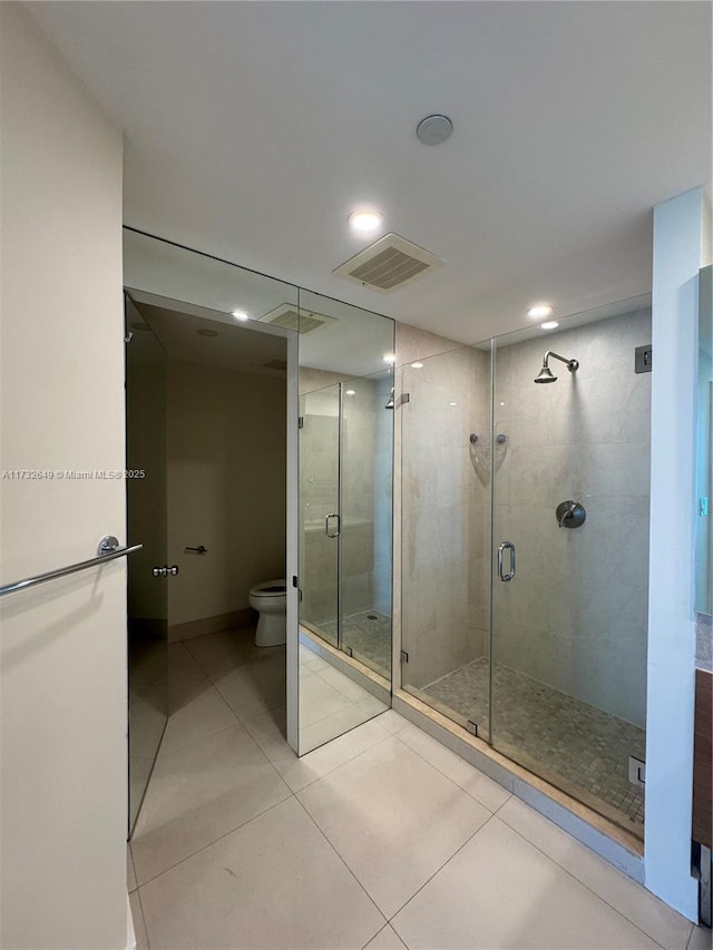 bathroom featuring walk in shower, toilet, and tile patterned flooring