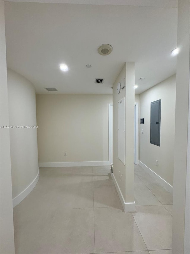 hallway with light tile patterned flooring and electric panel