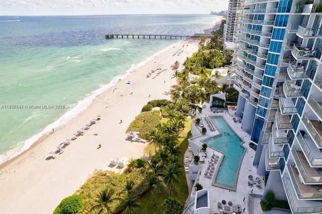 drone / aerial view with a beach view and a water view