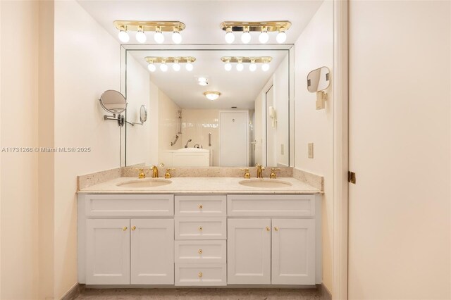 bathroom featuring vanity and a shower with door