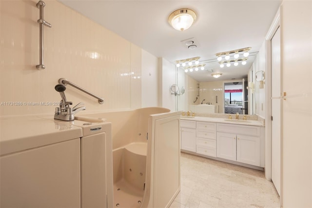 bathroom featuring vanity and a tub