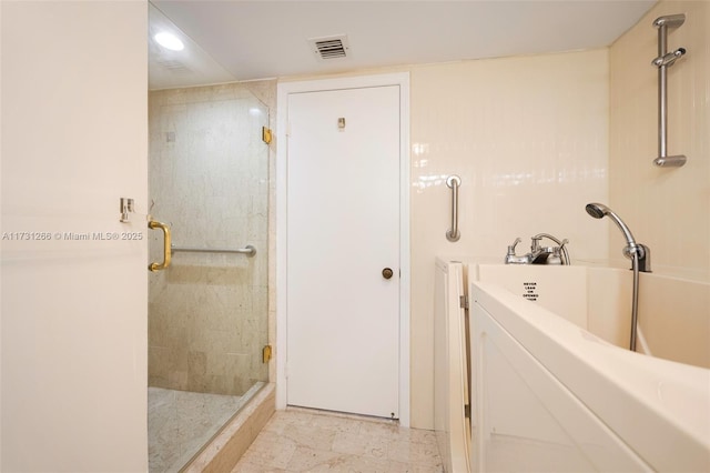 bathroom featuring walk in shower and washer / dryer