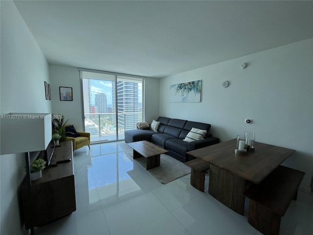 living room featuring expansive windows and light tile patterned floors