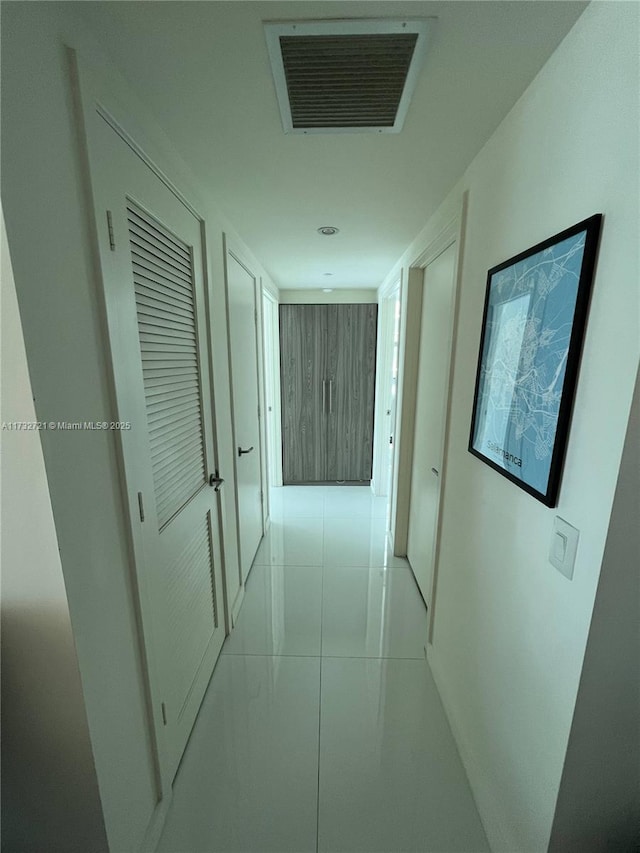 hallway featuring wooden walls