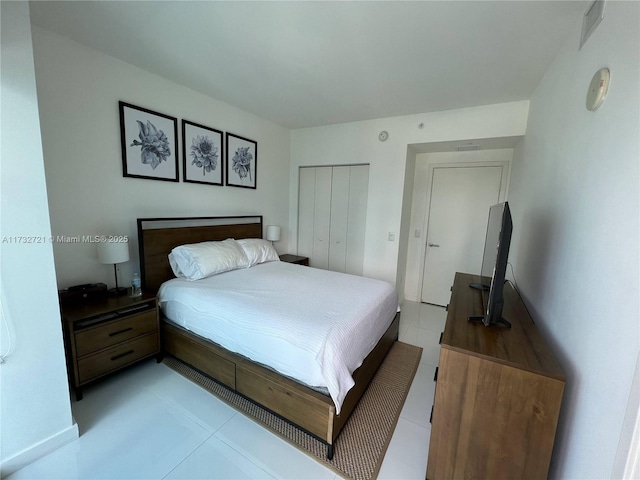 tiled bedroom featuring a closet