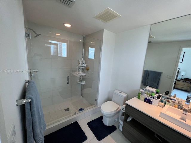 bathroom featuring tile patterned flooring, vanity, an enclosed shower, and toilet