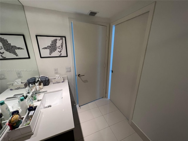 bathroom with tile patterned flooring and vanity