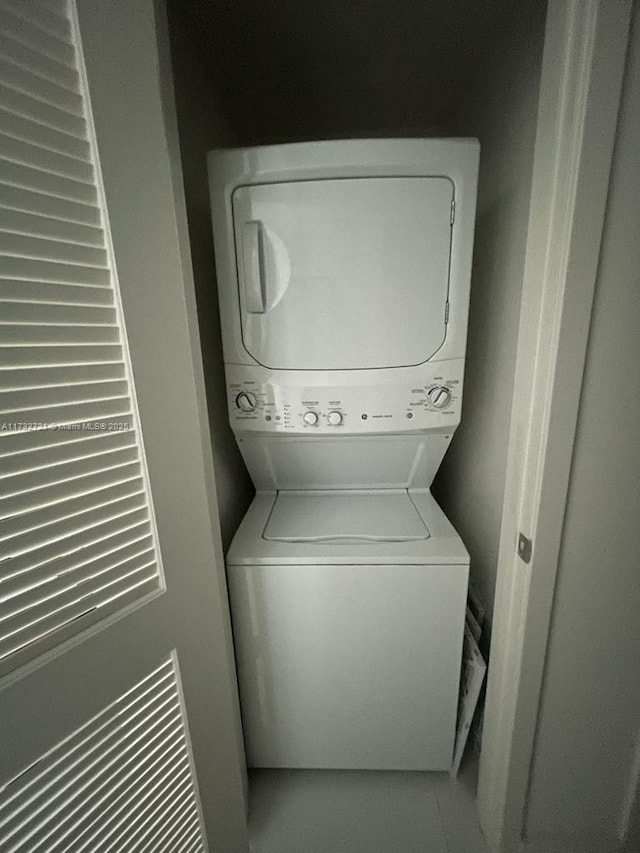 laundry area featuring stacked washer / dryer