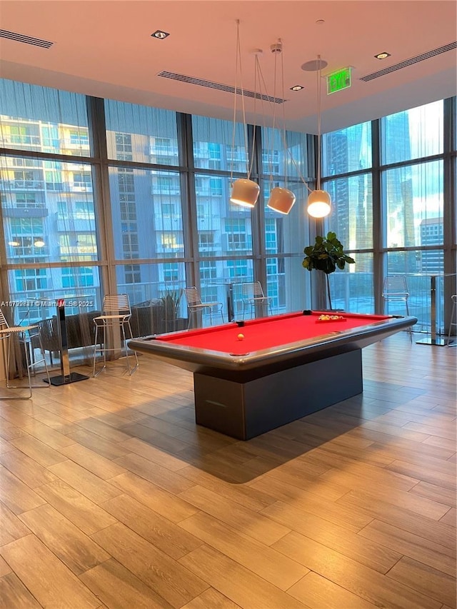 rec room featuring billiards, floor to ceiling windows, and light hardwood / wood-style floors