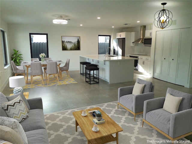 living room featuring sink and a notable chandelier